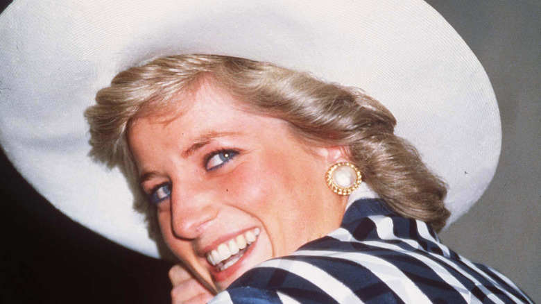 Princess Diana smiling in blue and white