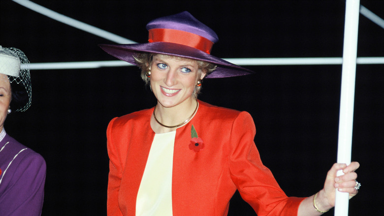 Diana Spencer wearing a red and purple outfit
