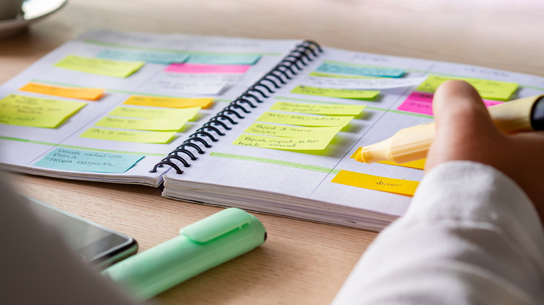 Planner covered with brightly colored sticky notes