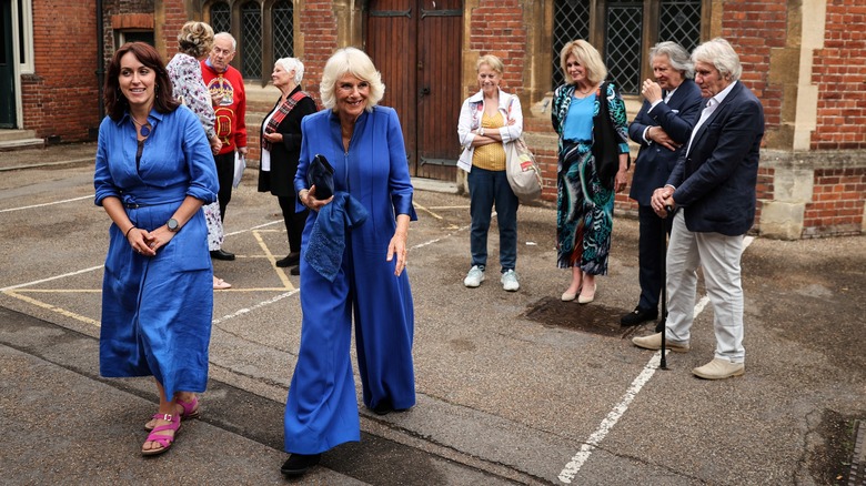 Queen Camilla strutting in a blue jumpsuit