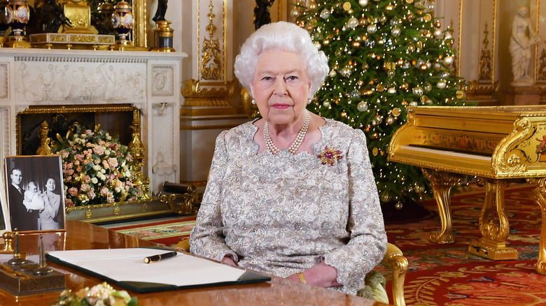 The Queen sits in gold