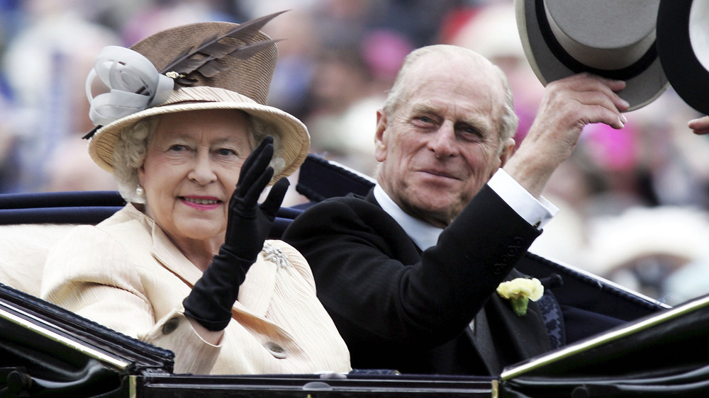 Queen Elizabeth and Prince Philip wave