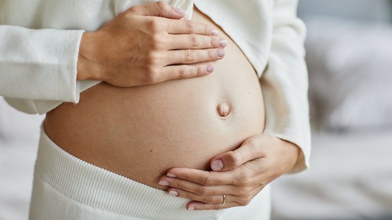 Woman holding her pregnant belly