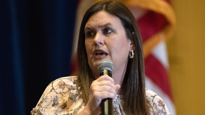 Sarah Huckabee Sanders speaking in microphone