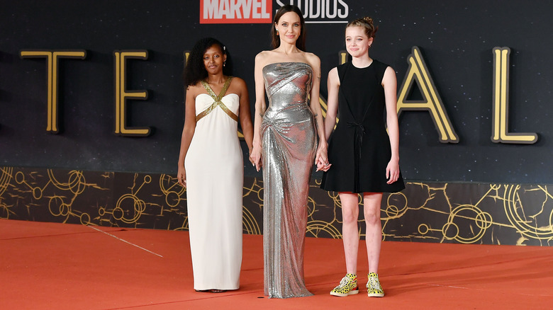 Shiloh Jolie-Pitt and Zahara Jolie-Pitt with Angelina Jolie on the red carpet