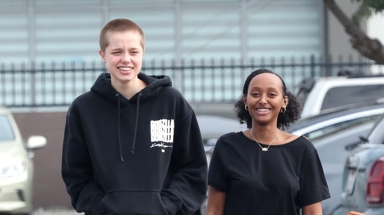 Shiloh Jolie-Pitt walking with Zahara Jolie-Pitt