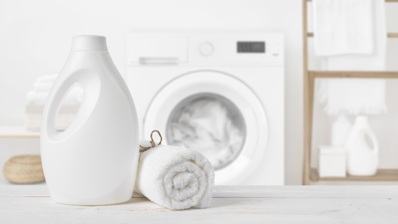 Detergent and towel on table in laundry room