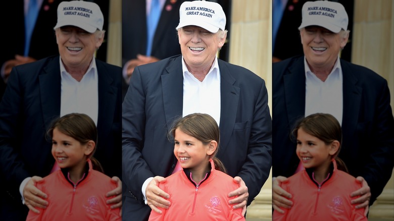 Kai Trump smiling in front of Donald Trump