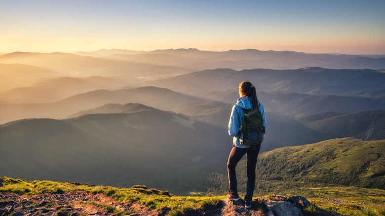 A woman at a mountain peak 