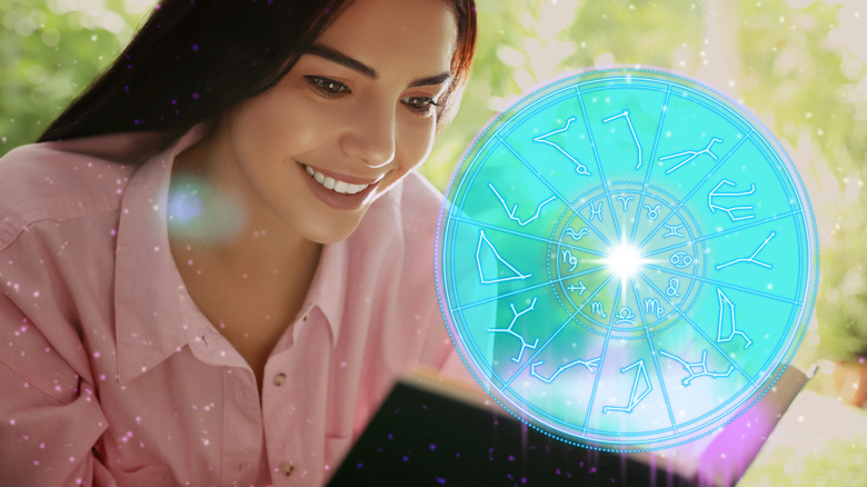 A woman reading a book and the zodiac wheel.  