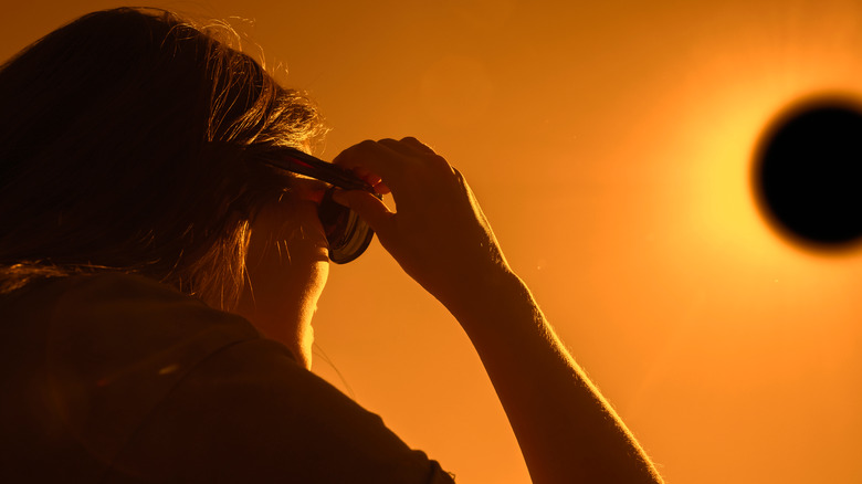 Woman watching a solar eclipse