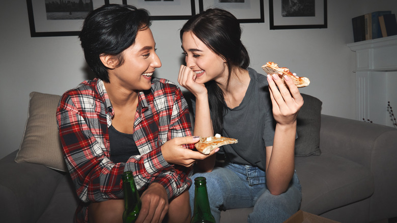 a couple flirting with pizza