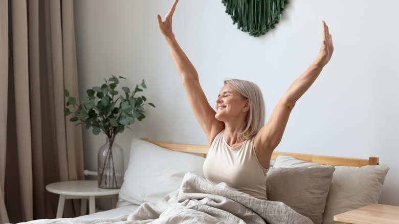 A woman stretching in bed. 