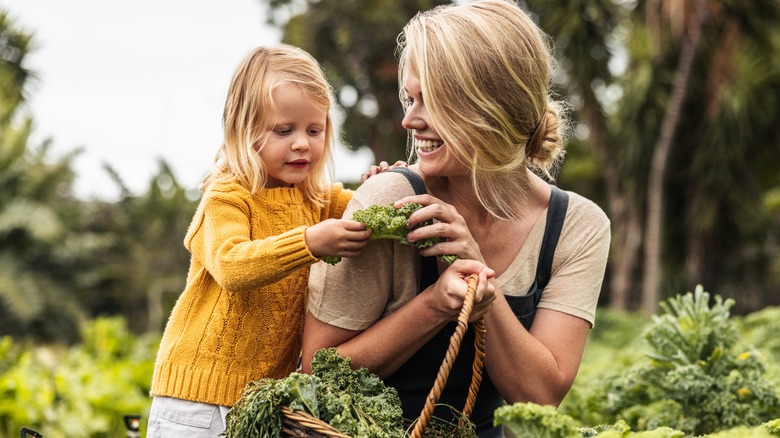 A mother and daughter in a garden. 