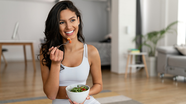 A woman eating a salad