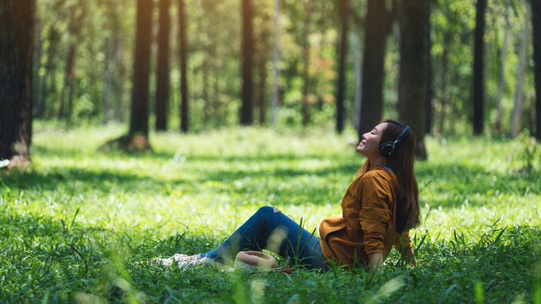 Woman meditating in forest 