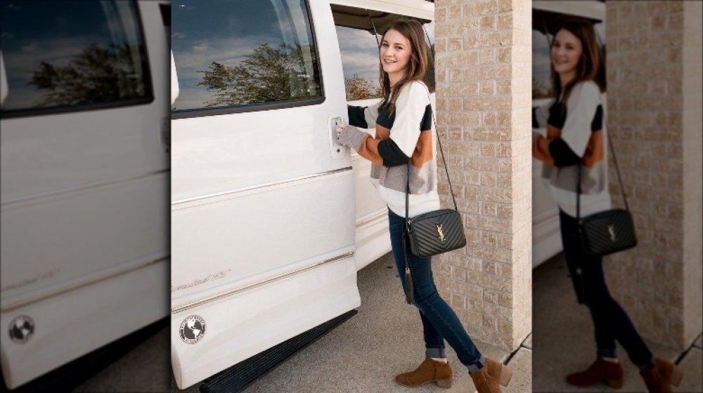 Danielle Busby from OutDaughtered with a YSL handbag