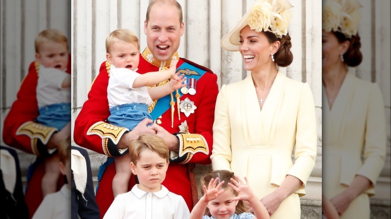 Prince William, Kate Middleton and three children smiling and watching from royal balcony