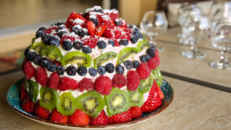 Cake decorated with fruit displayed on a table