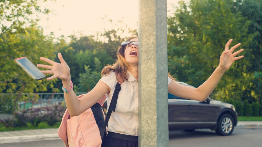 Woman on phone crashing into a pole