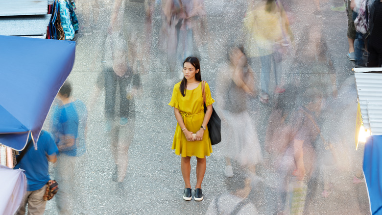 Woman standing on busy street