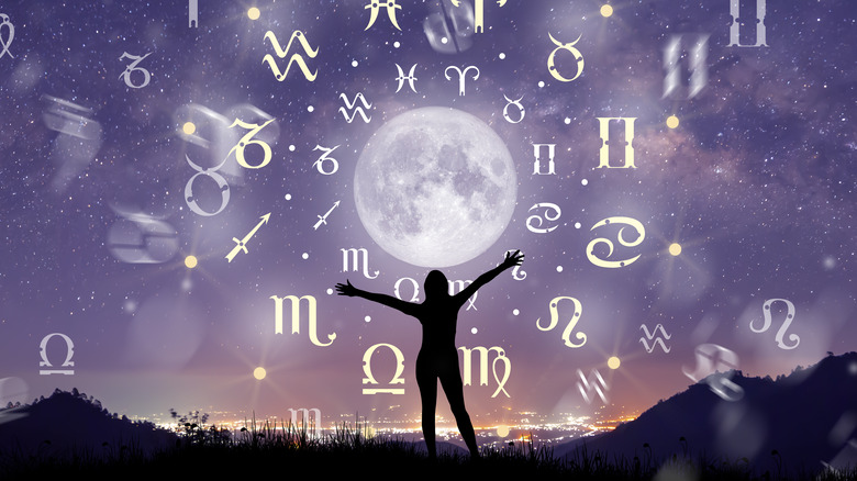 Zodiac sign holograms against twilight sky