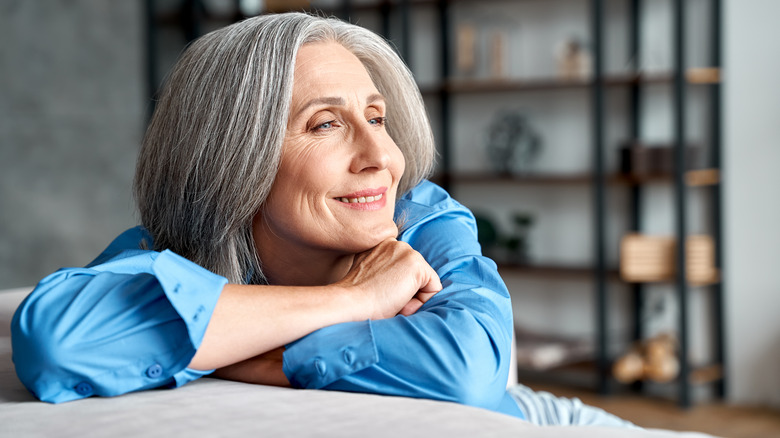 A woman relaxing on a couch. 