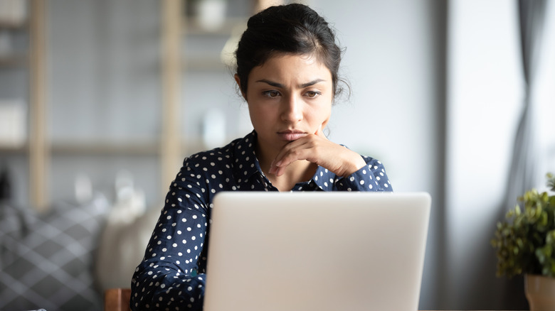 A woman working at a computer. 