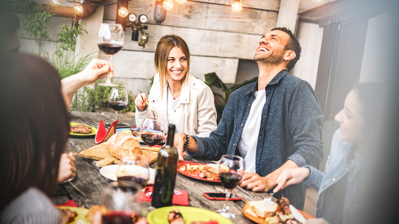 Woman laughing at dinner party