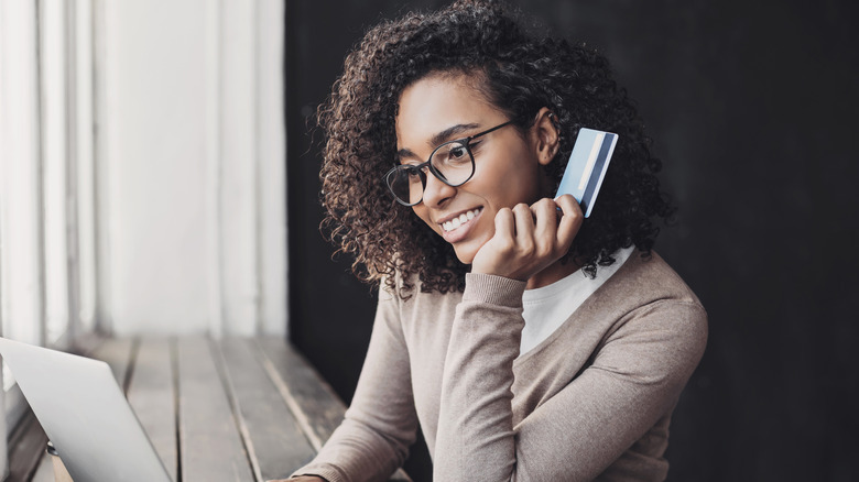 A woman holding a credit card