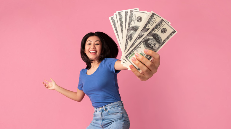 A woman holding money in her hand. 