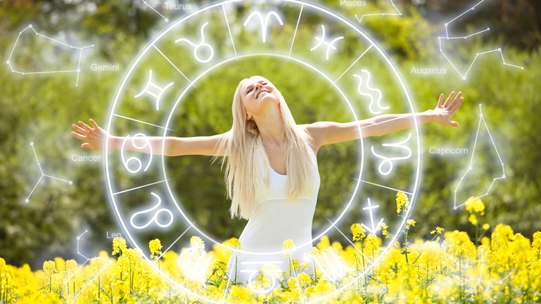 A woman enjoying the outdoors and a zodiac circle. 