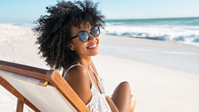 Black woman smiling at beach