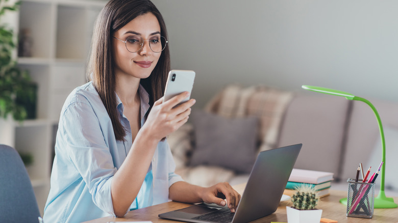 Woman with glasses cell phone and laptop