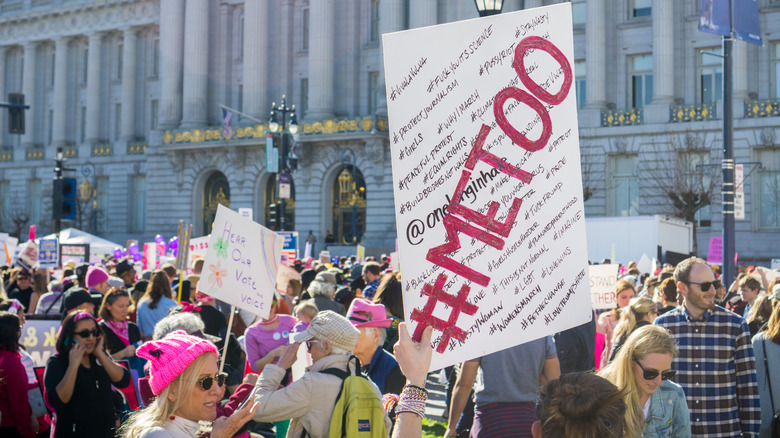 protestors with #metoo protest signs, marching