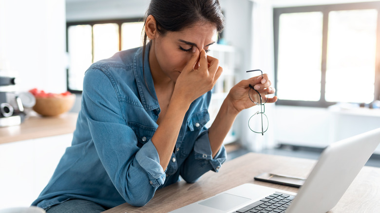 Woman pinching the bridge of her nose