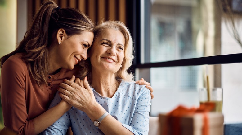 Woman embracing mother 