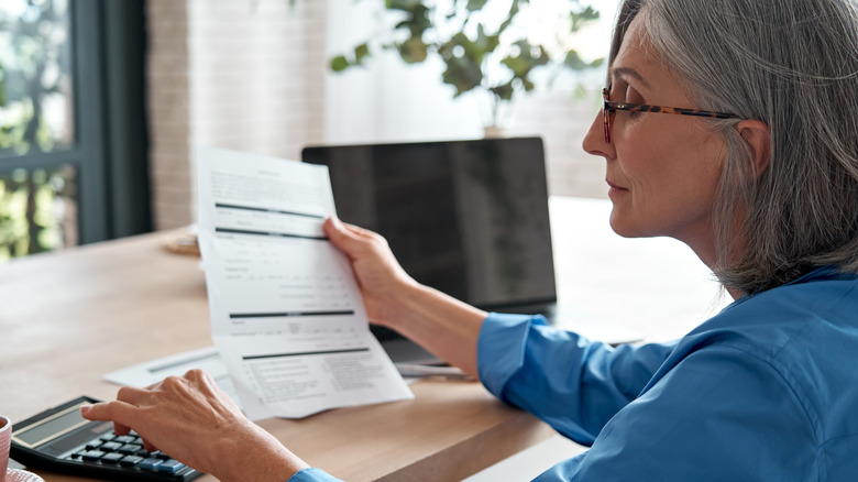 A woman looking over a document 