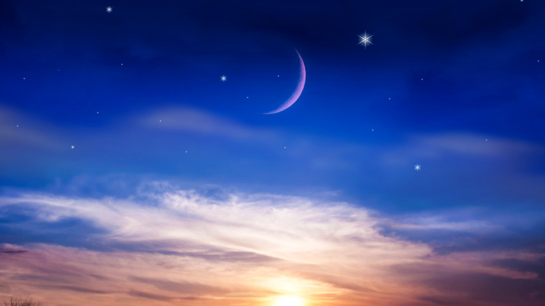 crescent moon in a sunset sky