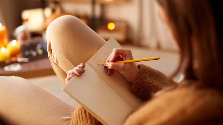 Woman writing in journal