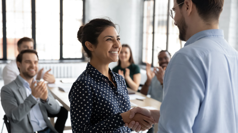 Woman shaking hands at work