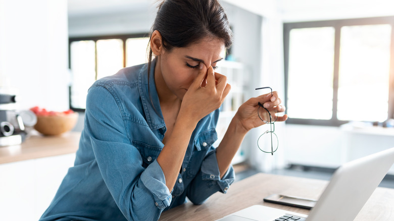 Woman overwhelmed while working