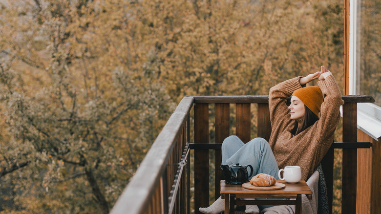 Woman sitting outside on a fall day