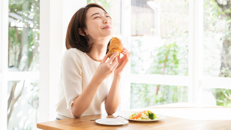 A woman enjoying some food. 