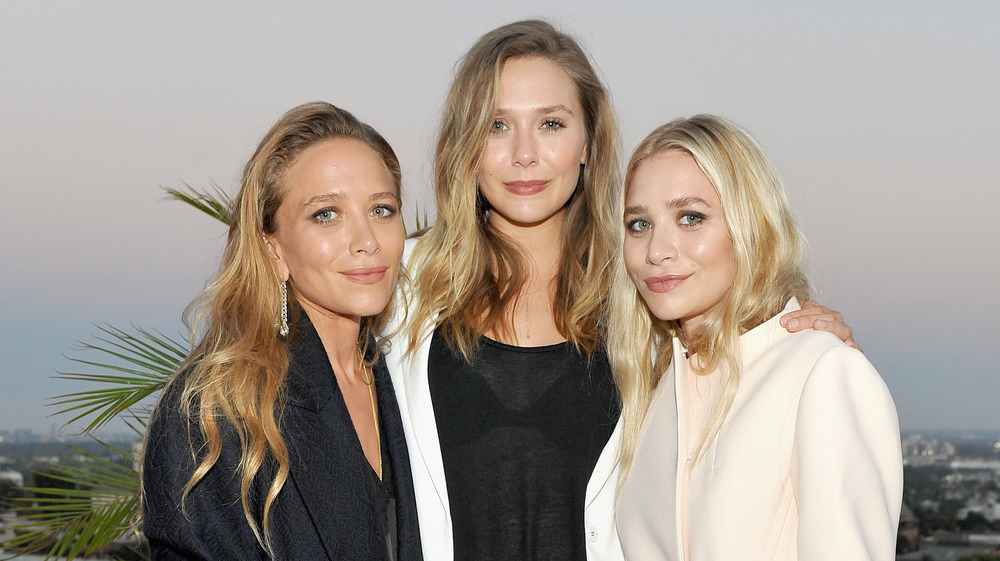 The Olsen twins posing with Elizabeth