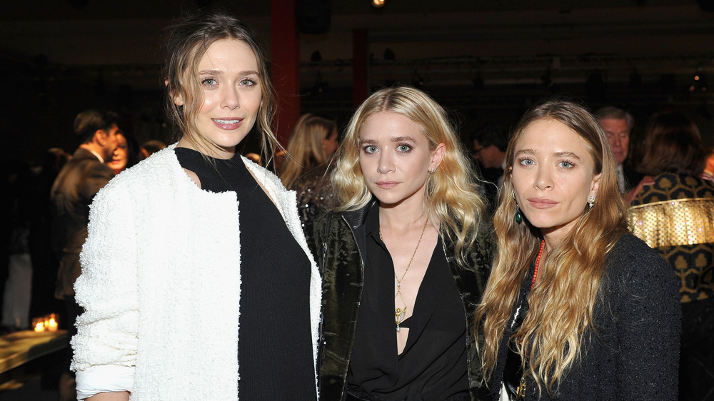 The Olsen twins posing with Elizabeth