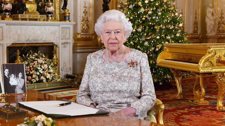 Queen Elizabeth in front of a Christmas tree