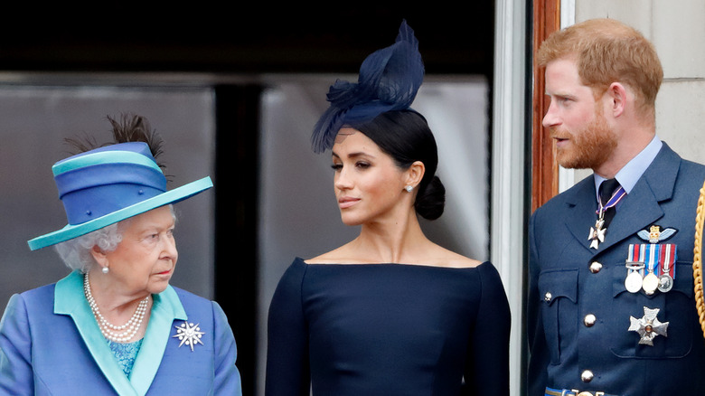 Queen Elizabeth with Prince Harry and Meghan Markle. 