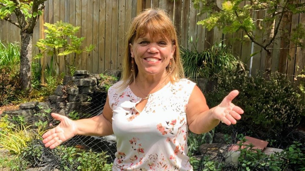 Amy Roloff from Little People, Big World smiling in a garden