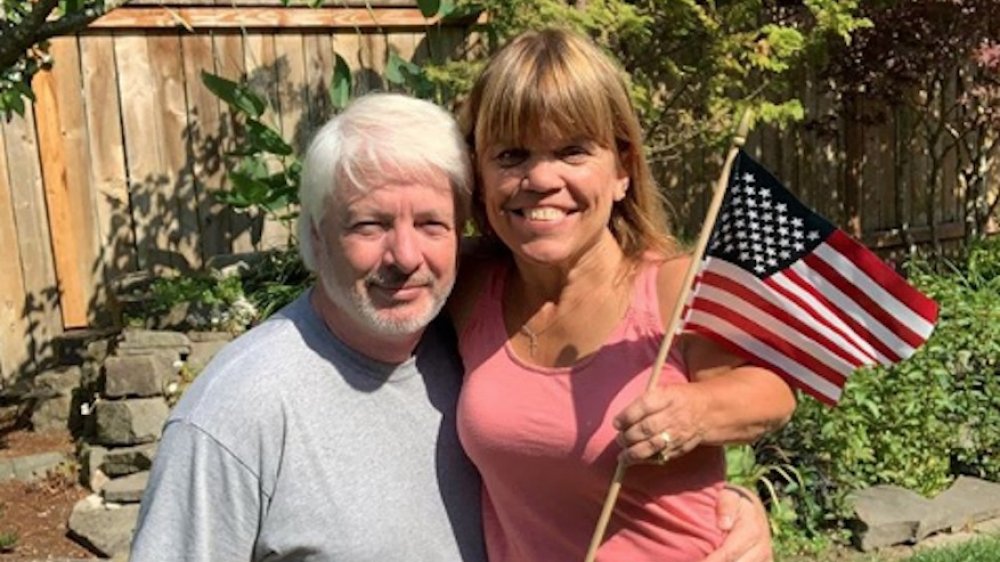 Chris Marek and Amy Roloff holding an American flag